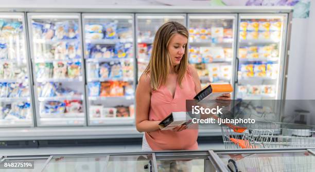 Photo Of Pregnant Woman Buying Vegetables In Frozen Section In Supermarket Stock Photo - Download Image Now