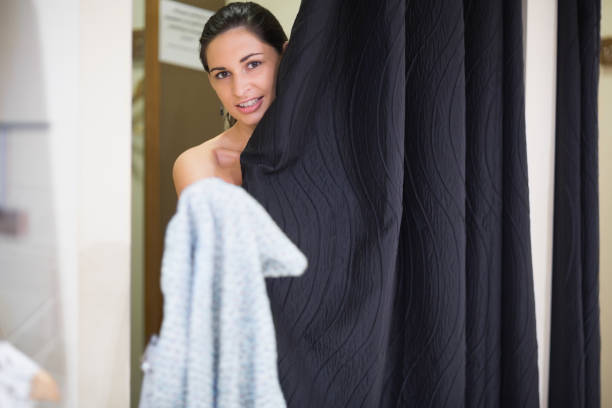 istock Woman standing behind curtain in changing room 848282792