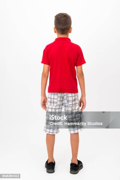 Rear View Of Little Boy Standing Over White Background Full Length Stock Photo - Download Image Now