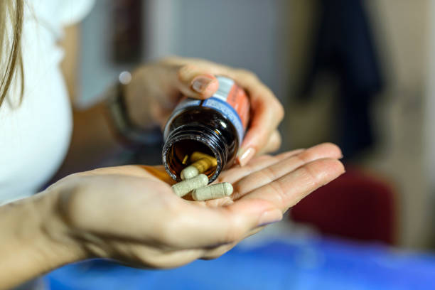 istock Close up of young  woman taking pill 848284804