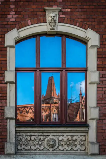 Window reflection of an old historical building in Bydgoszcz, Poland