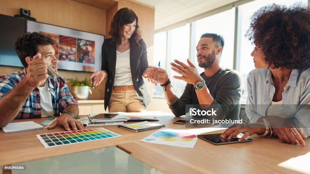 Group of multi ethnic people during business meeting Young and creative start-up team discussing ideas in board room. Group of multi ethnic people during business meeting. Advertisement Stock Photo