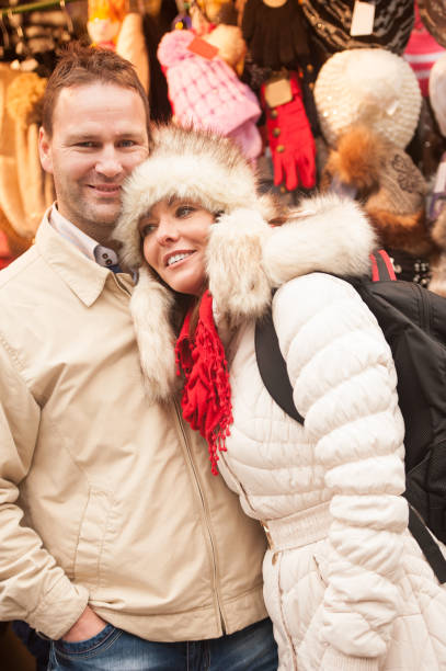 loving couple on christmas market in ljubljana - ljubljana december winter christmas imagens e fotografias de stock