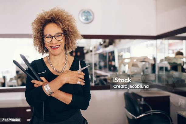 Female Hairdresser At The Salon Holding Hairdressing Tools Stock Photo - Download Image Now