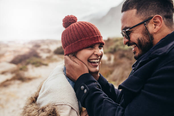 istock Smiling couple enjoying a winter day at the beach 848290996