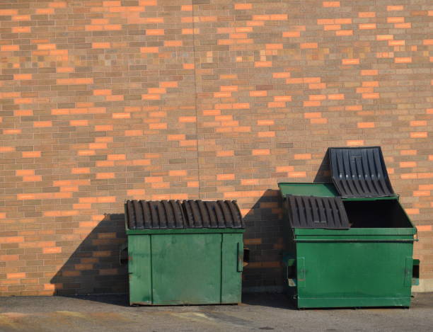 Green recycling dumpsters Green recycling dumpsters against a brick wall garbage bin photos stock pictures, royalty-free photos & images