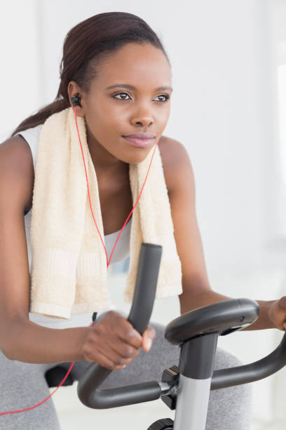 istock Concentrated black woman doing exercise bike 848296114