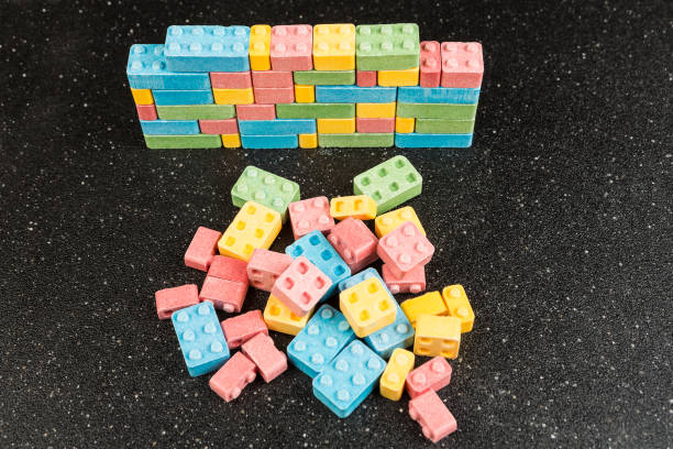 istock Pile of multicolored candy building blocks on a black background 848297446