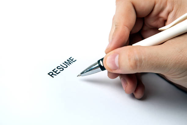 istock Man's hand on resume form and pen 848298290