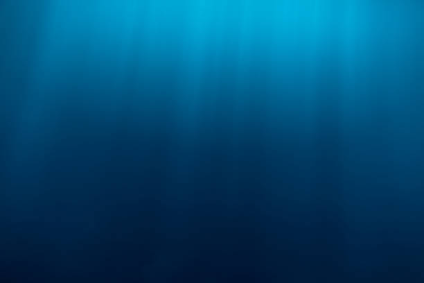 istock Water texture underwater and sun rays. Blue ocean in underwater 848298460