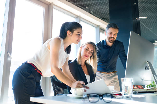 istock Three business people in the office working together. 848300718