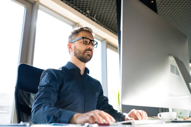 istock Businessman at the desk with computer in his office. 848300818