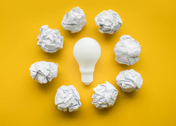 istock Creativity inspiration,ideas concept with lightbulb and paper crumpled ball 848304624