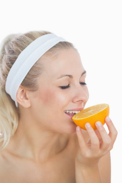 istock Woman enjoying slice of orange 848307880