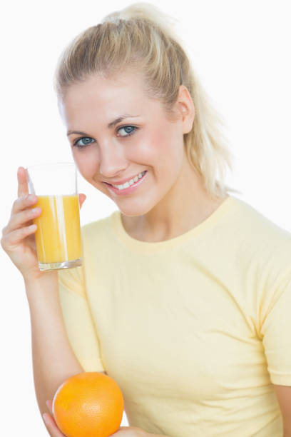 istock Happy woman holding juice and orange 848308162