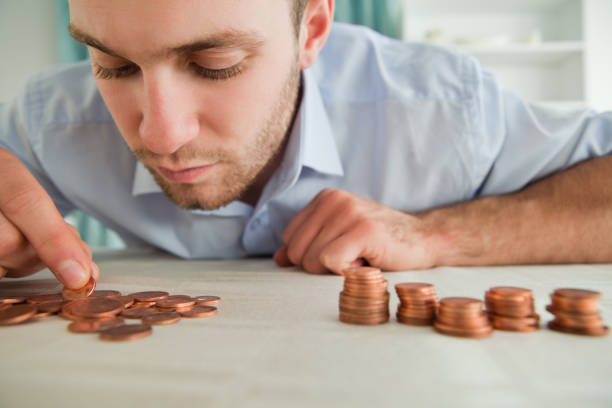 istock Businessman counting coins 848311160