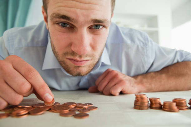 istock Desperate businessman counting his change 848311178
