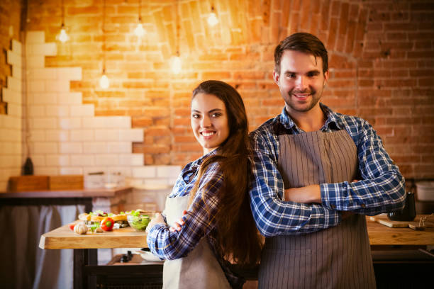 istock Young smiling couple cooking together 848311464