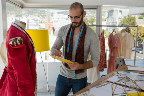 istock Designer writing on paper while standing by mannequin 848311570