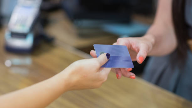 istock Woman handing over credit card 848316162