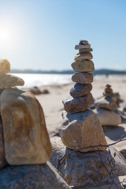 istock Pyramid of pebbles on the beach - stuck rocks 848316256