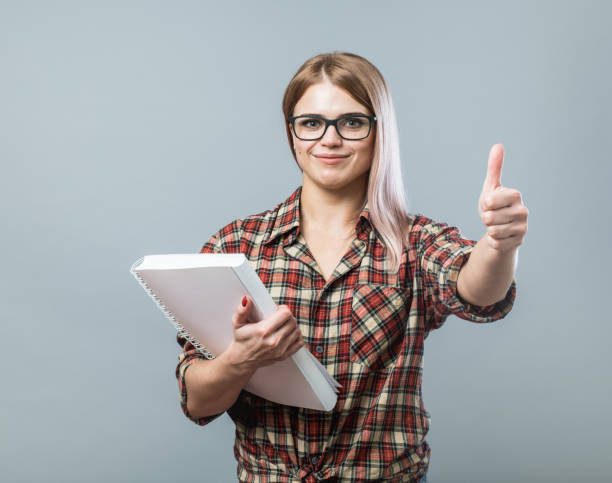 istock Young handsome girl holding book 848321926