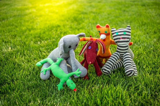 Toy friends on green grass. Handmade toys