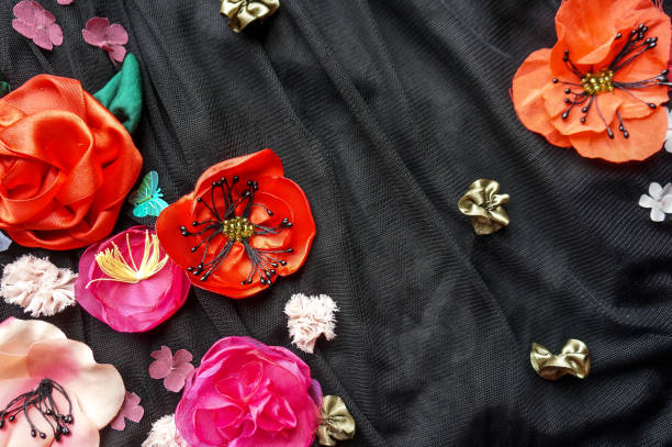 Silk flowers embroidery over black fabric background
