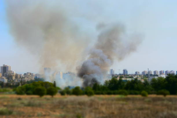 istock Fire in the field near the city 848327802
