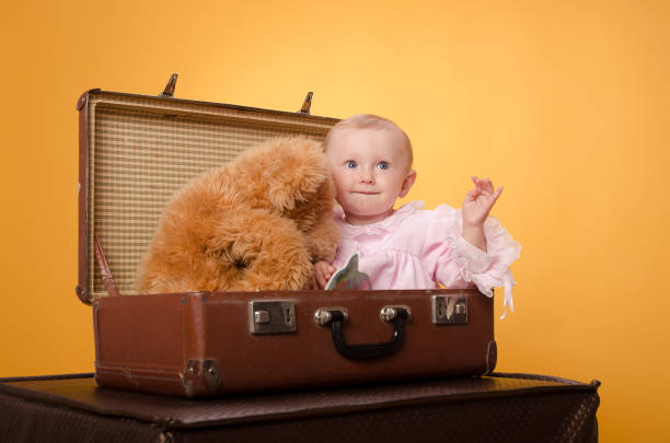 The baby in the bag, on an orange background