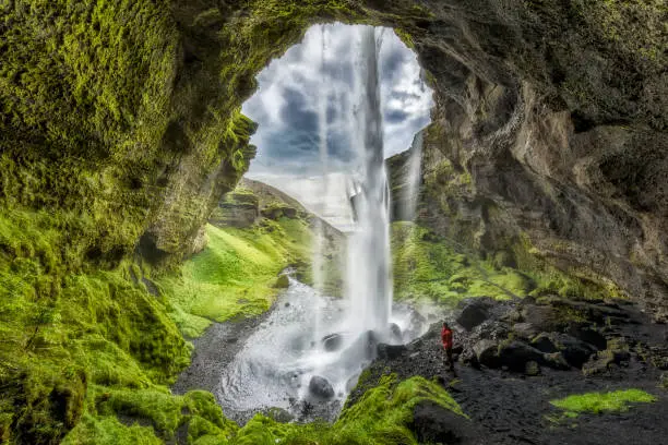 Photo of Hiker at Majestic Kvernufoss Waterfall in Iceland