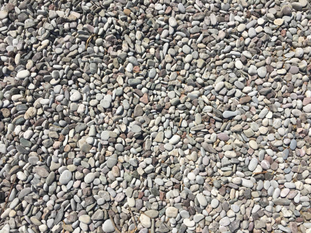 istock Gray pebbles stone texture and background. Abstract smooth round pebbles sea texture background. 848339596