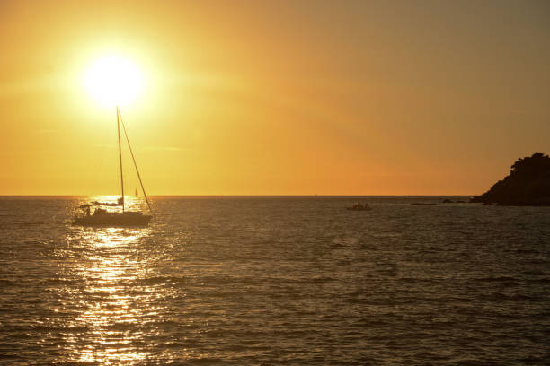 istock Sunset on the beautiful Adriatic beach and one sailboat 848342316