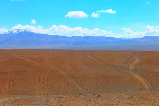 Photo of Dirt country roads - mountain pass to Salar de Tara - Dramatic Salar de Tara lagoon and rock formations - Idyllic Atacama Desert, Volcanic landscape panorama – San Pedro de Atacama, Chile, Bolívia and Argentina border