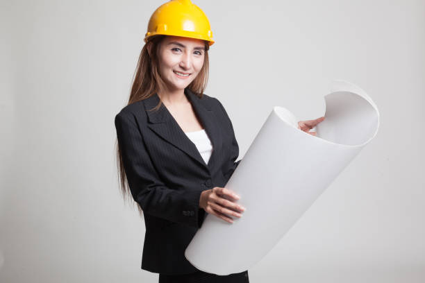 istock Asian engineer woman with blueprints. 848366062