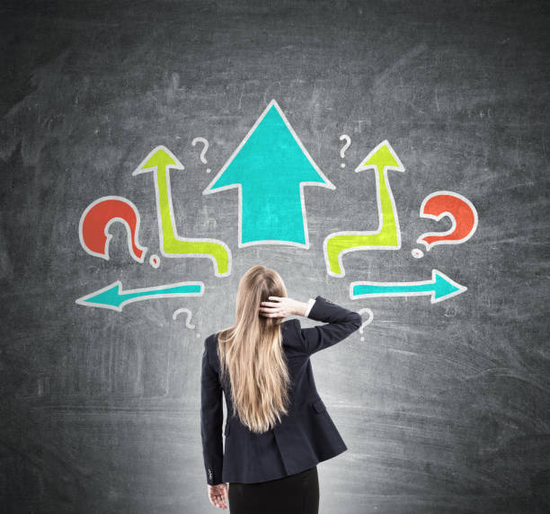 istock Woman scratching head, arrows and questions, rear 848366336