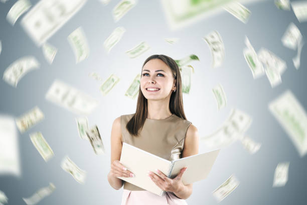 istock Happy blonde woman under a dollar rain 848366610