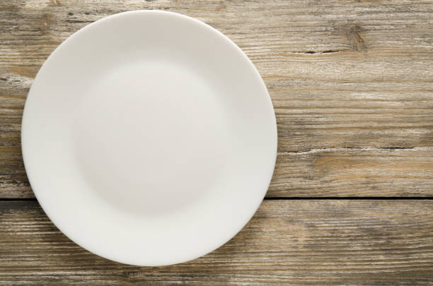 istock plate on a wooden background. plate top view. copy space 848377412