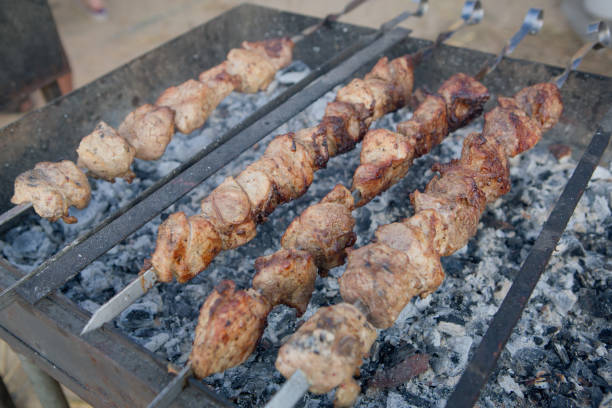 istock Barbecue. Fried shish kebab from pork meat. Fried chicken meat. Lamb on charcoal 848381136