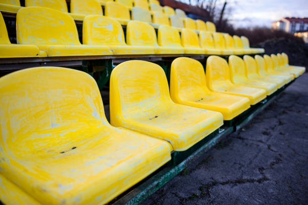 old yellow seat in stadium closeup