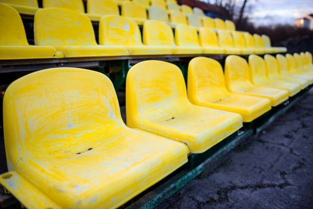 istock old yellow seat in stadium closeup 848397484