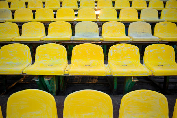 istock old yellow seat in stadium closeup 848397488