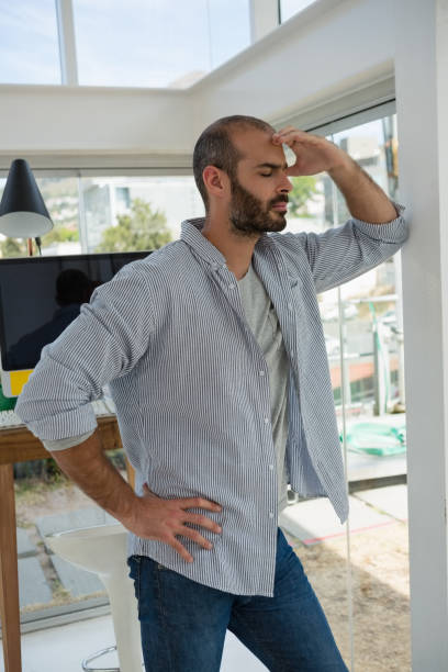 istock Tensed designer standing by wall 848397560