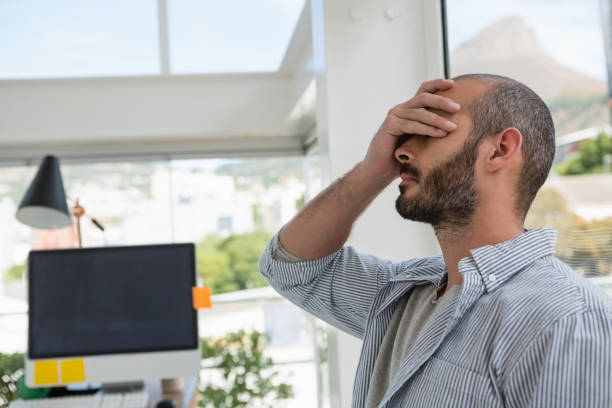 istock Frustrated designer leaning on glass window 848397694