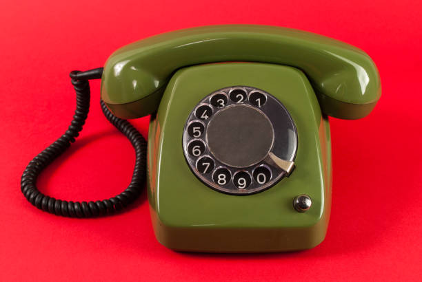 istock Old green phone on red background 848397712