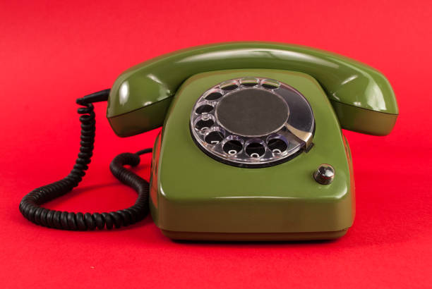 istock Old retro green phone on red background 848397714