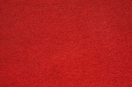Red felt table surface extremal close up. Large macro texture and background