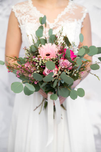 istock wedding pink bouquet in bride's hands white background 848402194