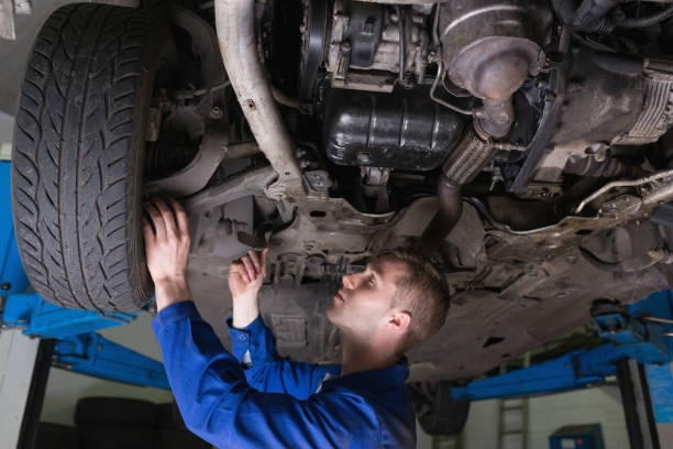 istock Mechanic under car in garage 848405504