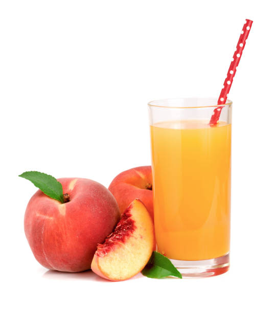 istock Glass of fruit juice with straw and cut peaches isolated on white background 848405708